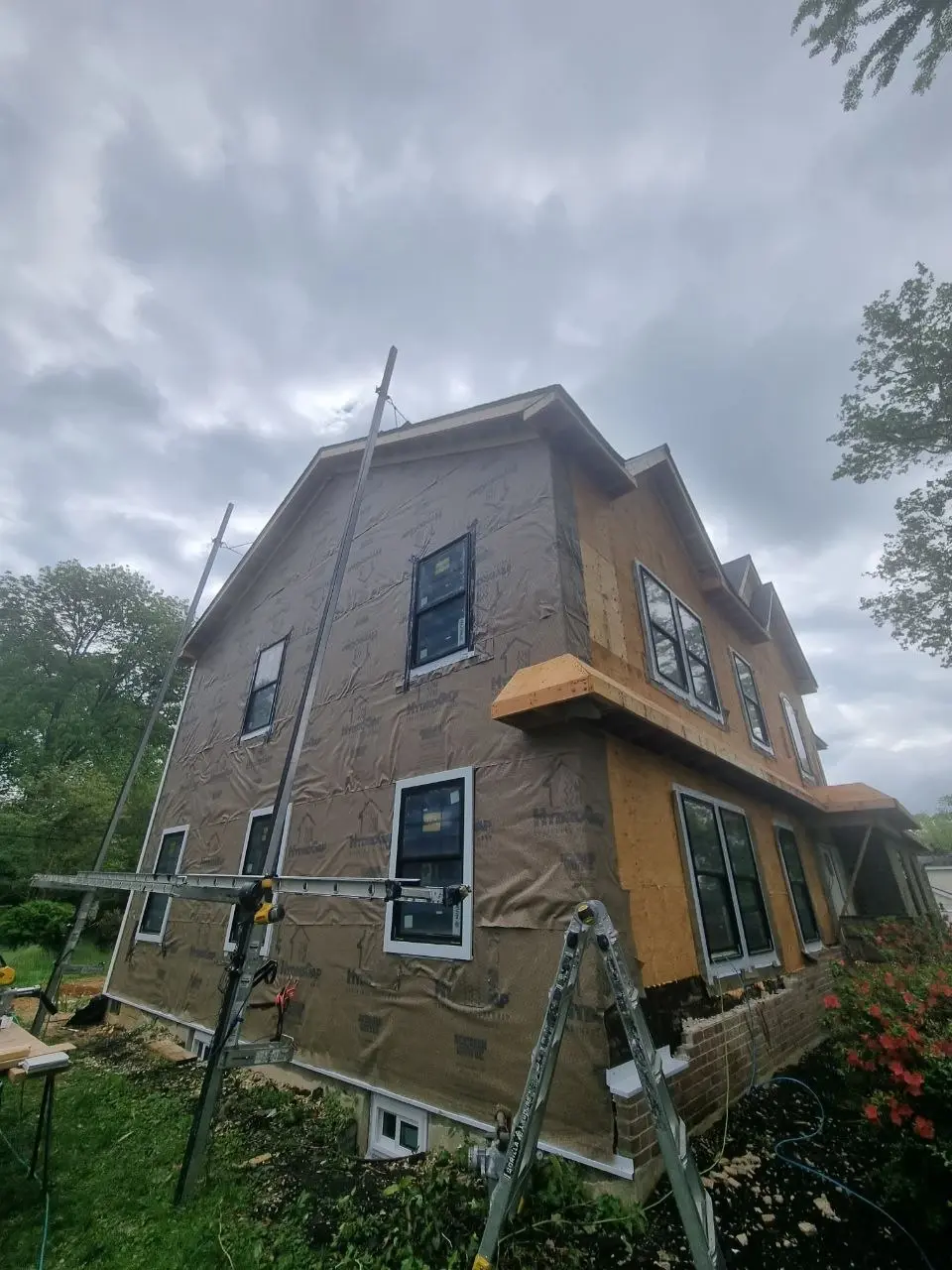Full tear-off siding replacement in progress on a residential home — photo 2