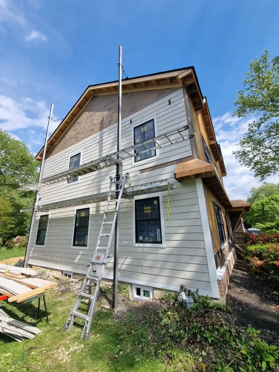 Full tear-off siding replacement in progress on a residential home — photo 3