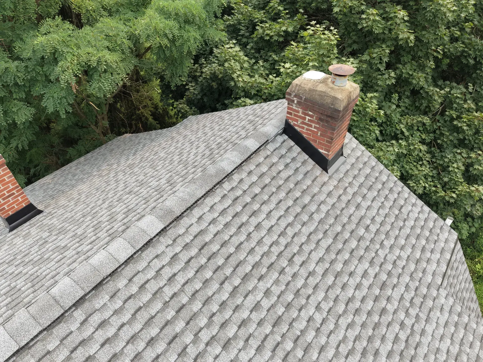Standing-seam metal roofing panels installed on a residential home — photo 4